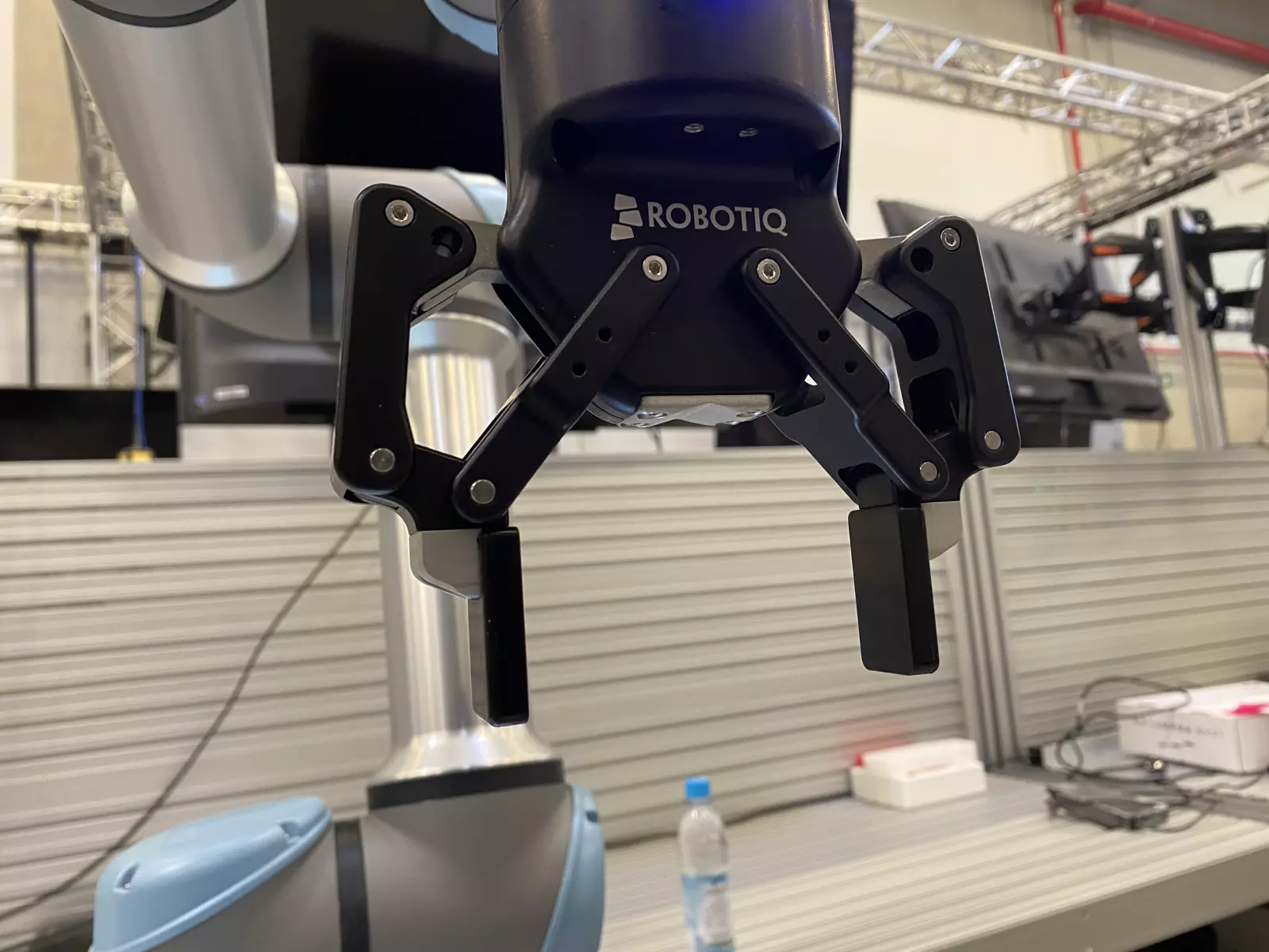 Small screws on the gripper are the keypoints. White blobs are detections; green lines are the 3D model edges projected with the PnP pose.